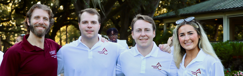 Loyola University Advocacy Center students in white shirts and director Evan Bergeron in a maroon shirt.